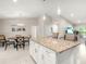 Open kitchen and dining area with a large island and modern pendant lighting at 6126 Spinnaker Blvd, Englewood, FL 34224