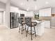 Bright kitchen featuring stainless steel appliances, granite countertops, and a central island at 6126 Spinnaker Blvd, Englewood, FL 34224