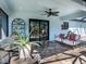 Cozy lanai with ample seating, decorative plants, and a ceiling fan for comfortable outdoor living at 6126 Spinnaker Blvd, Englewood, FL 34224