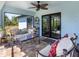 Charming lanai with comfortable seating, decorative plants, and sliding glass doors for indoor-outdoor living at 6126 Spinnaker Blvd, Englewood, FL 34224