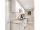 Efficient laundry room with granite countertops, modern appliances, and ample cabinet space at 6126 Spinnaker Blvd, Englewood, FL 34224