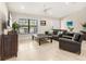 Inviting living room showcasing neutral paint, large windows, and sleek tile flooring at 6126 Spinnaker Blvd, Englewood, FL 34224