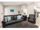 Comfortable living room featuring leather seating, tile floors, and stylish décor at 6126 Spinnaker Blvd, Englewood, FL 34224