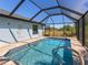 Inviting pool area enclosed with a screened lanai, offering privacy and a relaxing atmosphere at 6126 Spinnaker Blvd, Englewood, FL 34224