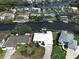 Scenic aerial view of a waterfront home nestled among canal-front properties and lush landscaping in a charming neighborhood at 617 Bonito Ave, Nokomis, FL 34275