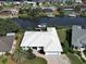 Aerial view of a waterfront home with boat dock in a neighborhood with canal access at 617 Bonito Ave, Nokomis, FL 34275