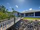 Backyard view with a stone walkway to the dock at 617 Bonito Ave, Nokomis, FL 34275