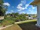 Picturesque backyard view with a canal, lush greenery, and neighboring docks under a bright sky at 617 Bonito Ave, Nokomis, FL 34275