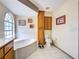 Well-lit bathroom with built-in cabinets, a large soaking tub, and a separate toilet area for added privacy at 617 Bonito Ave, Nokomis, FL 34275