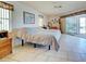 Bright bedroom with sliding glass door access to a screened porch or patio at 617 Bonito Ave, Nokomis, FL 34275