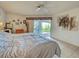 Bedroom with tile floors, bright natural light, and access to a patio through sliding glass doors at 617 Bonito Ave, Nokomis, FL 34275