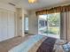 Cozy bedroom with sliding glass doors that lead to a screened patio at 617 Bonito Ave, Nokomis, FL 34275