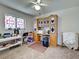 Bedroom featuring a large desk with built in shelving and natural light from a stained glass window at 617 Bonito Ave, Nokomis, FL 34275