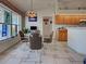 Bright dining area features a glass table, decorative lighting, and large windows with stained glass accents at 617 Bonito Ave, Nokomis, FL 34275