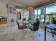 Charming dining area featuring water views, glass table, and access to the outdoor patio at 617 Bonito Ave, Nokomis, FL 34275