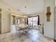 Bright dining room with tile floors, modern chandelier and display cabinet at 617 Bonito Ave, Nokomis, FL 34275