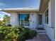 Side exterior view featuring a decorative bird perched on a railing, a well maintained yard and brick walk way at 617 Bonito Ave, Nokomis, FL 34275