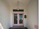 Close-up of an elegant double front door with decorative glass panels and a vintage-style lantern at 617 Bonito Ave, Nokomis, FL 34275