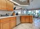 Well-equipped kitchen with stainless appliances, wood cabinetry, and seamless flow to the dining area at 617 Bonito Ave, Nokomis, FL 34275