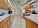 Spacious kitchen with wooden cabinets, stainless steel appliances, and a center island for cooking at 617 Bonito Ave, Nokomis, FL 34275