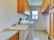 Practical laundry room with washer, dryer, sink, and storage cabinets for efficient chores at 617 Bonito Ave, Nokomis, FL 34275