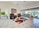 Spacious living room with tile floors, vaulted ceilings and sliding glass doors to patio at 617 Bonito Ave, Nokomis, FL 34275