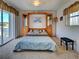 Serene main bedroom with built-in storage and furniture, soft carpet, and windows, creating a tranquil space at 617 Bonito Ave, Nokomis, FL 34275