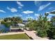 Waterfront scene with a boat docked, a well maintained yard, and brick walkway at 617 Bonito Ave, Nokomis, FL 34275