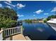 Scenic waterfront view featuring a private dock and canal access on a clear, sunny day at 617 Bonito Ave, Nokomis, FL 34275