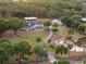 Aerial view showcasing the beautiful estate, pond and surrounding lush greenery, including barns at 6824 283Rd E St, Myakka City, FL 34251