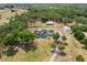 Aerial view of an estate with a grand home, outbuildings and mature trees at 6824 283Rd E St, Myakka City, FL 34251