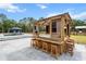 Custom outdoor bar with stools adjacent to the pool creates a great space for entertaining at 6824 283Rd E St, Myakka City, FL 34251