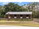 A quaint wooden barn with a metal roof, fenced yard, and surrounding trees at 6824 283Rd E St, Myakka City, FL 34251
