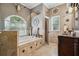 Bathroom showcasing a large soaking tub, decorative accents and natural stone at 6824 283Rd E St, Myakka City, FL 34251
