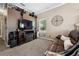 Bedroom with a large TV, a leather sofa, and a window, plus decorative accents at 6824 283Rd E St, Myakka City, FL 34251