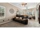 Bedroom with neutral walls, a large sofa and windows, plus ceiling fans for added comfort at 6824 283Rd E St, Myakka City, FL 34251