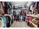 Walk-in closet featuring ample hanging space and multiple shelving units at 6824 283Rd E St, Myakka City, FL 34251