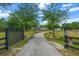 Long driveway leading to a beautiful home, surrounded by lush trees, offering privacy at 6824 283Rd E St, Myakka City, FL 34251
