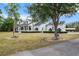 Elegant two-story home featuring a well-manicured lawn and charming exterior details at 6824 283Rd E St, Myakka City, FL 34251