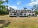 Picture-perfect home with a spacious front yard, mature trees, and a welcoming front porch at 6824 283Rd E St, Myakka City, FL 34251