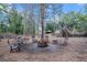 Cozy outdoor fire pit area with seating amidst tall trees at 6824 283Rd E St, Myakka City, FL 34251