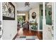 Bright foyer with hardwood floors and decorative wall art leading into a cozy living area at 6824 283Rd E St, Myakka City, FL 34251