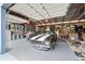 Well-organized garage featuring a classic car, ample storage, work benches, and a high ceiling at 6824 283Rd E St, Myakka City, FL 34251