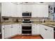 Bright kitchen features stainless steel appliances, granite countertops, and stylish white cabinetry at 6824 283Rd E St, Myakka City, FL 34251
