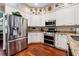 Spacious kitchen with stainless steel appliances, white cabinets, and granite countertops at 6824 283Rd E St, Myakka City, FL 34251