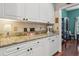 Additional kitchen counter space with white cabinets and granite countertops at 6824 283Rd E St, Myakka City, FL 34251