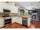 Well-equipped kitchen featuring stainless steel appliances and an open layout to the living area at 6824 283Rd E St, Myakka City, FL 34251