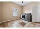 The spacious laundry room boasts tile floors, a window for natural light, and modern washer and dryer units at 6824 283Rd E St, Myakka City, FL 34251