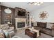 Comfortable living room features fireplace, TV, and ceiling fan at 6824 283Rd E St, Myakka City, FL 34251