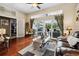 Spacious living room with hardwood floors and sliding glass doors opening to outdoor patio at 6824 283Rd E St, Myakka City, FL 34251